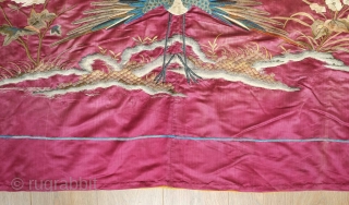 Qing Chinese hanging, late 19th century. The fabulous peacock tands with opened tail in exceptional embroidered detail with two dragons facing each other above.  The dragons are four clawed and are  ...