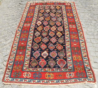 Genje rug, 19th century.  A real blitz of color on a midnight indigo field.  Pink, purple, apricot, green - at least 11 colors.  Overall good condition with two small  ...