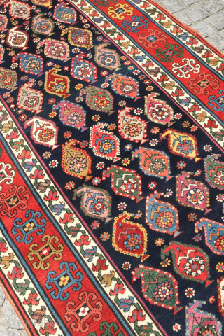 Genje rug, 19th century.  A real blitz of color on a midnight indigo field.  Pink, purple, apricot, green - at least 11 colors.  Overall good condition with two small  ...