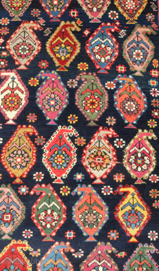 Genje rug, 19th century.  A real blitz of color on a midnight indigo field.  Pink, purple, apricot, green - at least 11 colors.  Overall good condition with two small  ...