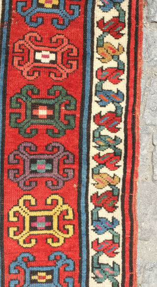 Genje rug, 19th century.  A real blitz of color on a midnight indigo field.  Pink, purple, apricot, green - at least 11 colors.  Overall good condition with two small  ...