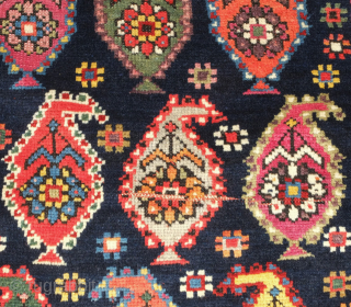 Genje rug, 19th century.  A real blitz of color on a midnight indigo field.  Pink, purple, apricot, green - at least 11 colors.  Overall good condition with two small  ...