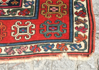 Genje rug, 19th century.  A real blitz of color on a midnight indigo field.  Pink, purple, apricot, green - at least 11 colors.  Overall good condition with two small  ...