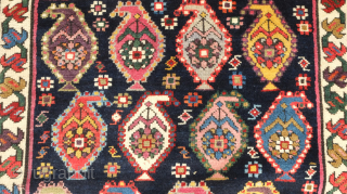 Genje rug, 19th century.  A real blitz of color on a midnight indigo field.  Pink, purple, apricot, green - at least 11 colors.  Overall good condition with two small  ...