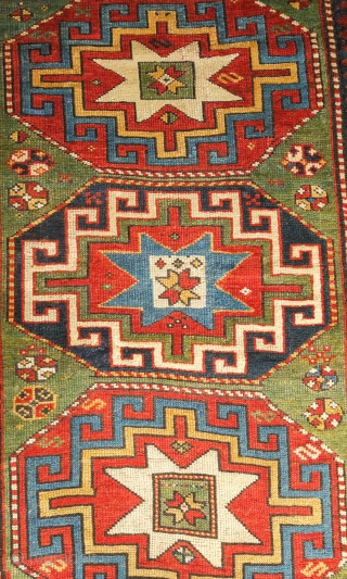 Kazak or Moghan rug, 4th quarter of the 19th century.  Simple, large Memling gul design and a stunning array of colors.  Wonderful lobbed floral border.  159 x 200 cm 