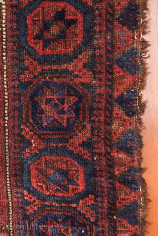 Baluch saddle bag face, late 19th century.  The central motif is in four abstracted dragon motifs surrounding an eight-pointed star.  The outer border is in a repeating swastika motif harkening  ...