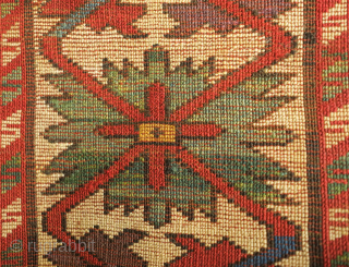 Kazak rug, 19th century.  Excellent weave and good colors including a wonderful yellow-green and purple.  Crisp drawing. Lower pile but otherwise excellent condition.  143 x 230 cm   