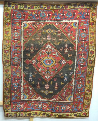 Bijar rug, 19th century.  Vivid colors, abstract pendants with rings of colors and human and small animal figures littering the field.  128 x 156 cm      