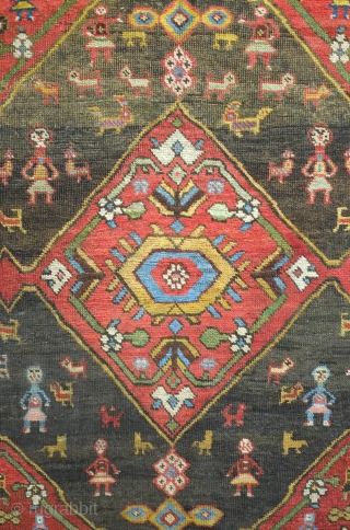 Bijar rug, 19th century.  Vivid colors, abstract pendants with rings of colors and human and small animal figures littering the field.  128 x 156 cm      