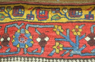 Bijar rug, 19th century.  Vivid colors, abstract pendants with rings of colors and human and small animal figures littering the field.  128 x 156 cm      