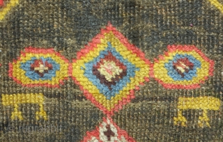 Bijar rug, 19th century.  Vivid colors, abstract pendants with rings of colors and human and small animal figures littering the field.  128 x 156 cm      