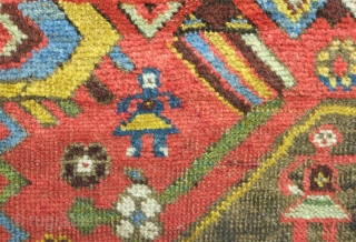 Bijar rug, 19th century.  Vivid colors, abstract pendants with rings of colors and human and small animal figures littering the field.  128 x 156 cm      