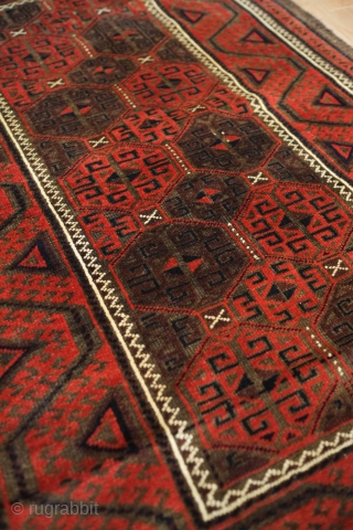 Baluch rug from the fourth quarter of the 19th century.  The wool is excellent quality and soft.  The design is in a repeat hooked octagon motif in rich reds and  ...