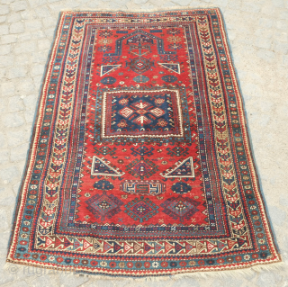 Kazak prayer rug dated to 1907(1322). Some wonderful archaic graphic elements on a deep red ground. It has a couple of very small areas of re-piling and a small section on the  ...