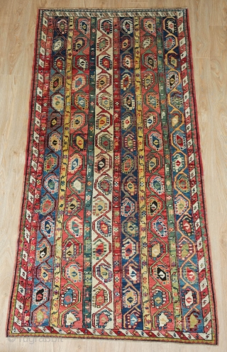 Genje Shawl Design Rug, 4th quarter of the 19th century.  Wonderful array of colors, counting around seven.  The Kashmir boteh shawl design is elegantly articulated in wider stripes than usual.  ...