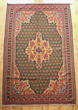 Senneh Kilim, 2nd quarter of the 20th century.  Great natural colors.  Field full of pink and green flowers.  A rich, striking kilim.  140 x 207 cm.   