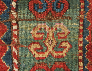 Fachralo green ground rug, 19th century. Wonderful field of green, kochanak border and elibelinde motifs on both ends of the field. Obvious wear but all there. 142 x 234 cm   
