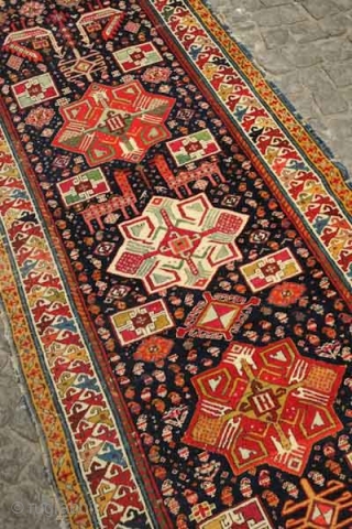 Akstafa long rug, 19th century.  Excellent colors generously applied.  The wool is extremely soft and velvet-like.  Two inward facing speckled camelids in the center.  I count around 9  ...