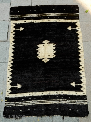 Siirt Rug, Early 20th century.  This rug was woven in three panels on a narrow loom and  stitched together.  It has a serrated pendant in the center flanked by  ...