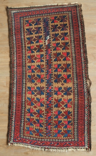 Khorasan Baluch rug, late 19th century.  Tree of life design over a camel wool ground.  Vivid purple in the leaves.  Some damage on one side of the selvedge.   ...