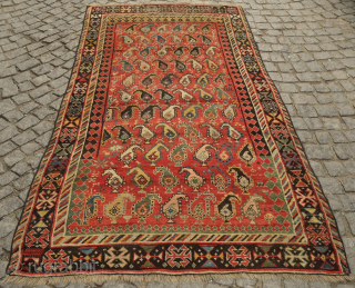 Genje or other Caucasus region rug, late 19th century.  The boteh are in juxtaposing directions in alternating rows.  The colors are beautiful green, pink and indigo.  Note the crosses  ...