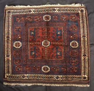 Timuri Baluch saddle bag face, 19th century.  Four abstracted dragons or mythical creatures in the corners of the central field. Eight-pointed stars symmetrically arranged around the inner border.  80 x  ...