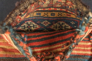 Qashqa'i Chanteh, 19th century.  Deep green-blue ground.  Vivid striped back.  Well executed soumak work on the top.  All good colors.  Selvedge missing and there is a small  ...