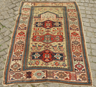 Kuba prayer rug, dated to 1884 according to the mixed Arabic and Western numbers in the inscribed date. Yellowish ground.  Kufic borders. Double headed birds and animals in the field.   ...