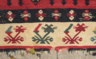 Sarkoy kilim, 19th century.  Beautiful saturated cochineal ground with zigzagging branches.  Playful animalistic floral motifs along the white borders.  A kilim that resonates despite its obvious damage.  334  ...