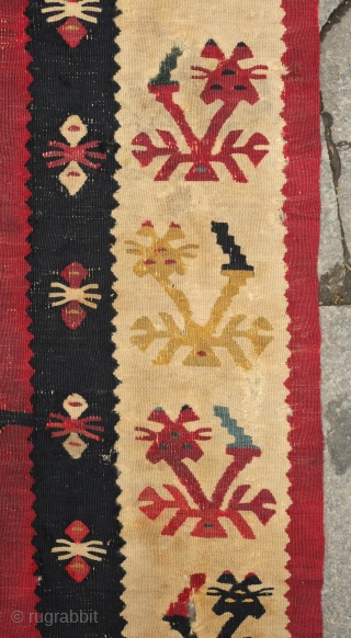 Sarkoy kilim, 19th century.  Beautiful saturated cochineal ground with zigzagging branches.  Playful animalistic floral motifs along the white borders.  A kilim that resonates despite its obvious damage.  334  ...