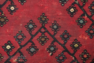 Sarkoy kilim, 19th century.  Beautiful saturated cochineal ground with zigzagging branches.  Playful animalistic floral motifs along the white borders.  A kilim that resonates despite its obvious damage.  334  ...