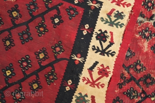 Sarkoy kilim, 19th century.  Beautiful saturated cochineal ground with zigzagging branches.  Playful animalistic floral motifs along the white borders.  A kilim that resonates despite its obvious damage.  334  ...