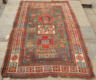 Fachralo green ground rug, 19th century. Wonderful field of green, kochanak border and elibelinde motifs on both ends of the field.  Obvious wear but all there. 142 x 234 cm  