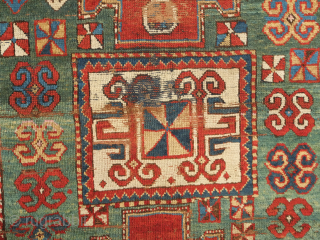 Fachralo green ground rug, 19th century. Wonderful field of green, kochanak border and elibelinde motifs on both ends of the field.  Obvious wear but all there. 142 x 234 cm  