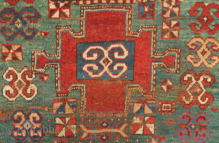 Fachralo green ground rug, 19th century. Wonderful field of green, kochanak border and elibelinde motifs on both ends of the field.  Obvious wear but all there. 142 x 234 cm  
