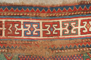 Fachralo green ground rug, 19th century. Wonderful field of green, kochanak border and elibelinde motifs on both ends of the field.  Obvious wear but all there. 142 x 234 cm  