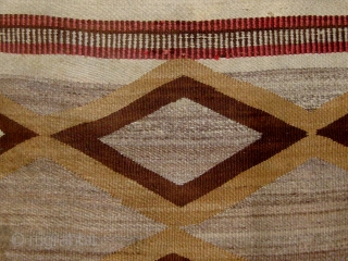 Antique Navajo weaving (first quarter of the 20th century) incorporating both tapestry and twill weave, 39" by 65", natural wool colors with aniline dyed red wool.       