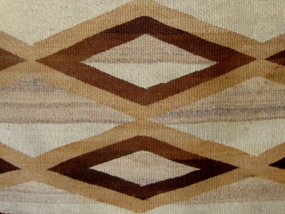 Antique Navajo weaving (first quarter of the 20th century) incorporating both tapestry and twill weave, 39" by 65", natural wool colors with aniline dyed red wool.       