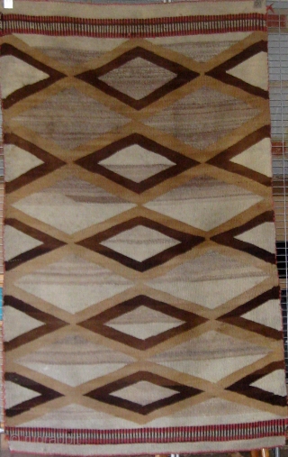 Antique Navajo weaving (first quarter of the 20th century) incorporating both tapestry and twill weave, 39" by 65", natural wool colors with aniline dyed red wool.       