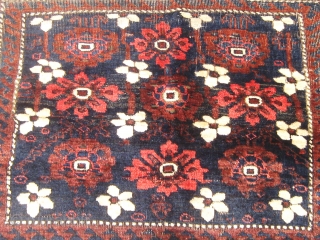 Rare type antique Baluch bag face, 19th century, white flowers on a dark pool, all natural dyes, wonderful silky wool, some wear mostly around the periphery as shown, 24" by 35".   ...