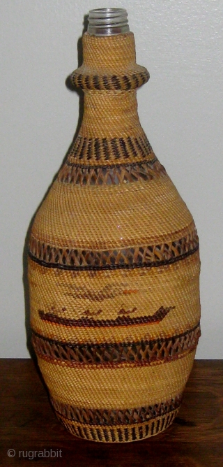 Antique Native American Northwest Coast Nootka-Makah polychrome twined bottle basket, consisting of a bottle covered with fine weave of cedar bark and bear grass.  Solid bands alternating with open lattice work.  ...