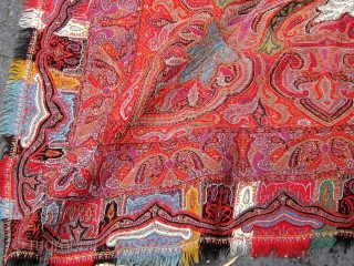 Antique Kashmiri paisley shawl, 19th Century, approximately 76" square--fairly large for its type--in good condition with complete embroidered borders, the usual bites in the black center.       