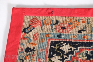 Antique Tibetan mat or seat cover, first quarter of the 20th century, 23" by 30", with original edging and backing.             