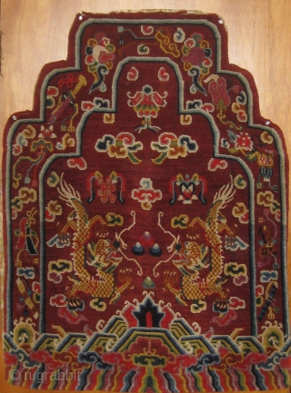 Rare antique Tibetan throne back cover, early 20th century, in pristine condition with original brocade back.  Approximately 15 colors.  Definitely Tibetan made, cut Senneh loop on wool foundation.  For  ...