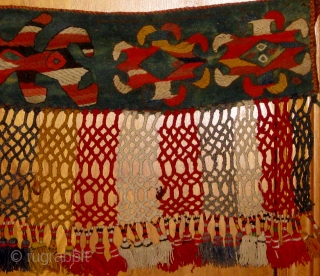 Early 20th Century Uzbek trapping with unusual shamanistic motifs. Wool and felt.  35" by 17" including fringe.  Please ask for additional photos.         