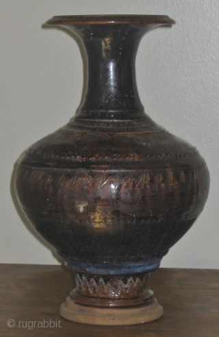 Angkor period (12th Century) Khmer glazed baluster jar, with incised scalloped decoration on shoulder and foot, and carved rings on the mouth, shoulder, and foot.  Please ask for additional photos.  
