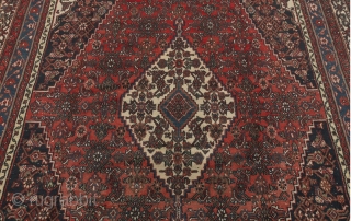 Semi-Antique Persian Dargazin Carpet;

14'8" x 11'6";

Medium low wool pile on cotton weft. Field with central lozenge shape medallion within extensions, stylised floral design on ruby red; corner guards on navy blue, ivory  ...