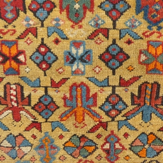 This is a great Caucasian Kuba.
It has a beautiful gold colored field and nice design.
However, it does have it's share of problems.
Both end areas have damage and very poor repairs.
The pile is  ...