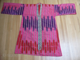 All silk Adras striped Uzbek ikat Kurta. Early 2oth century. Sleeves 66xlength 45in (168x114cm).Excellent silk embroidered frontal trim .Unusual 3 color (Pink, red and Purple). ikat Condition wearable with no tears, holes,  ...