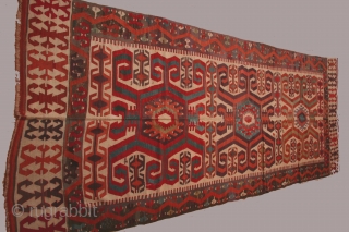 Anatolian kilim with three large central medallions, 5 x 14 feet, circa 1800. condition: substantial reweaving of black in borders, some reweaving in the field as well. The composition of the elements  ...